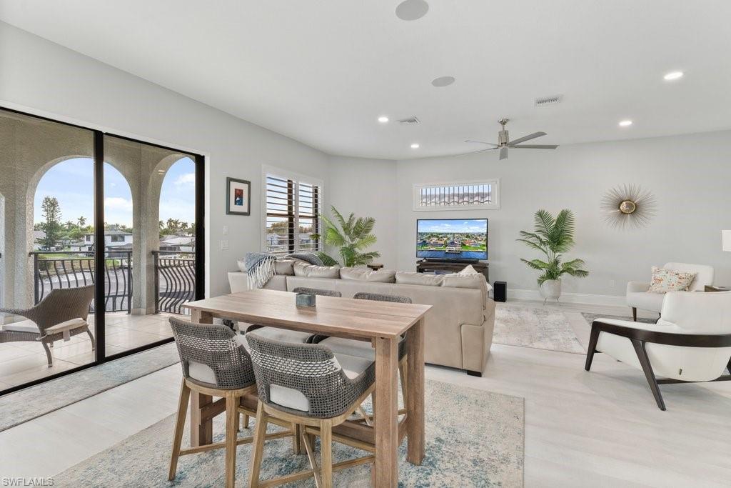 Dining room featuring light wood-style floors, ceiling fan, and recessed lighting
