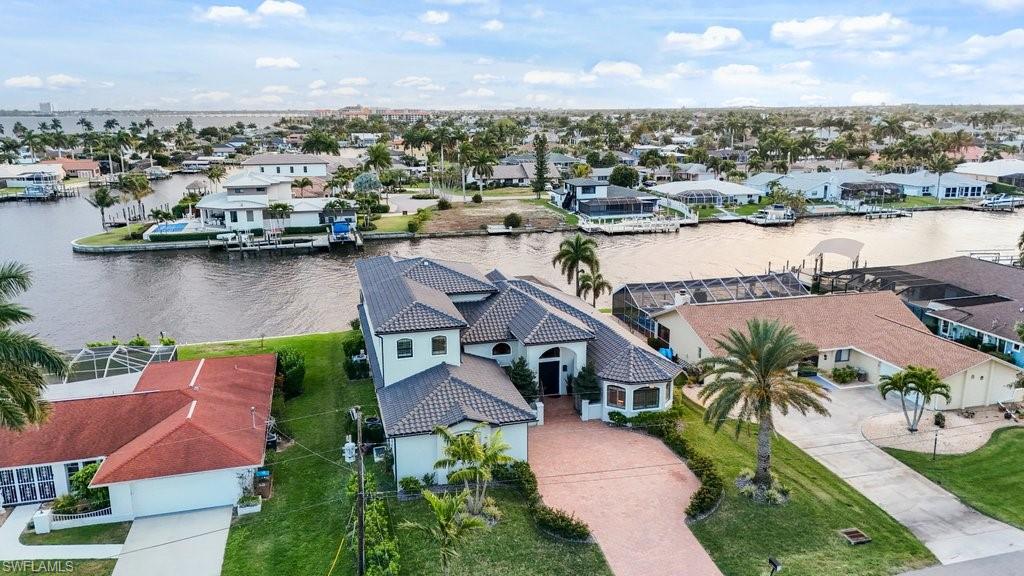 Aerial view of residential area featuring a nearby body of water
