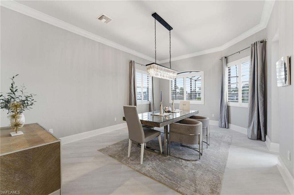Dining room featuring plenty of natural light and ornamental molding