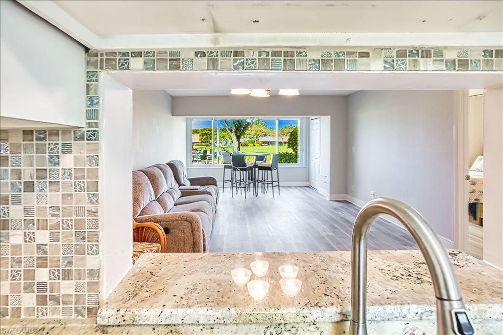 Living area with light wood finished floors and baseboards