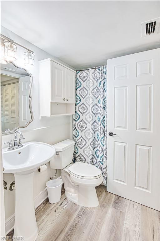 Bathroom featuring light wood-style floors and a shower with shower curtain