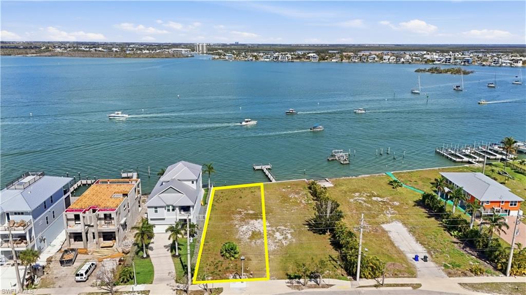 Aerial view of residential area featuring property parcel outlined - Virtually Edited Image