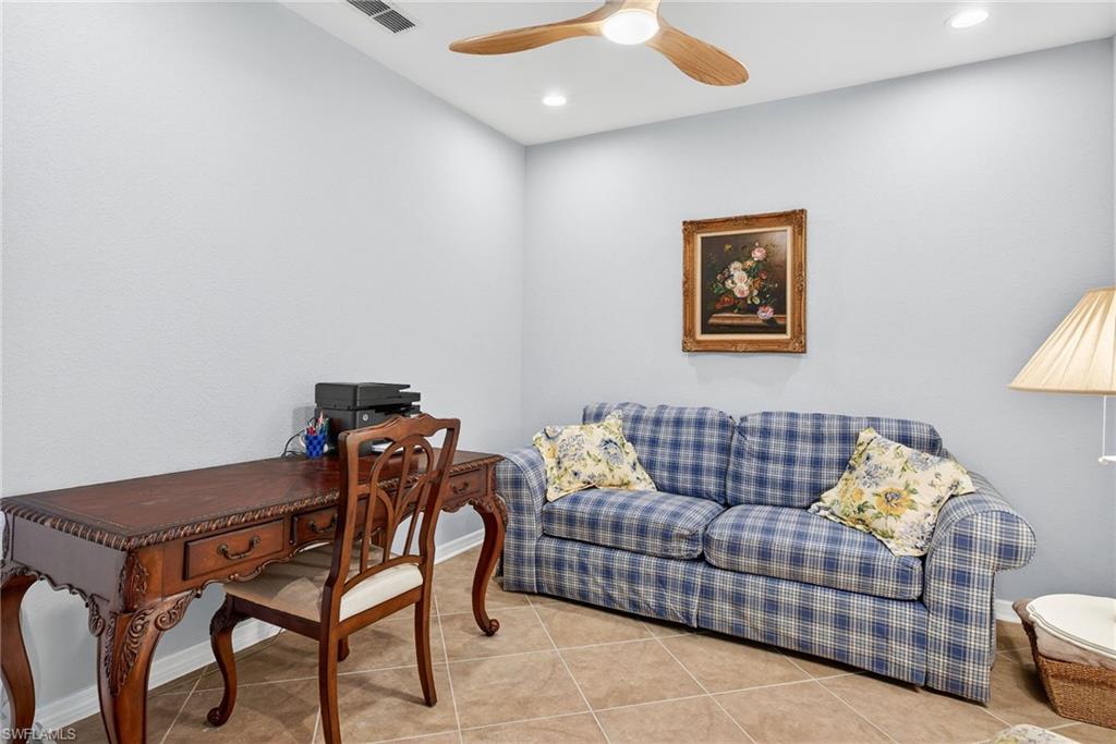 Tiled home office featuring ceiling fan and recessed lighting