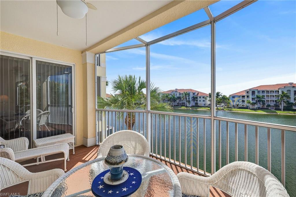 Sunroom with a water view and wood finished floors