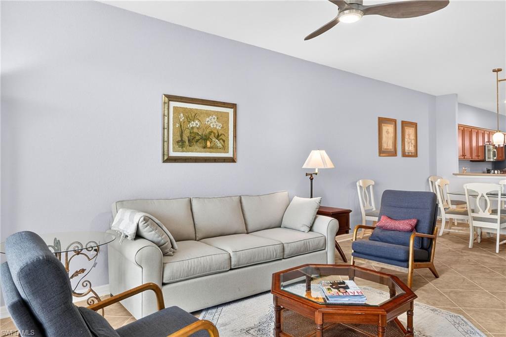 Living area featuring ceiling fan and light tile patterned floors