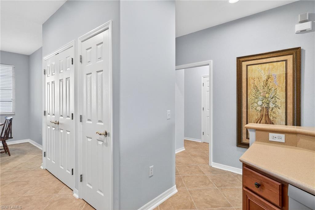 Hall with light tile patterned floors and baseboards