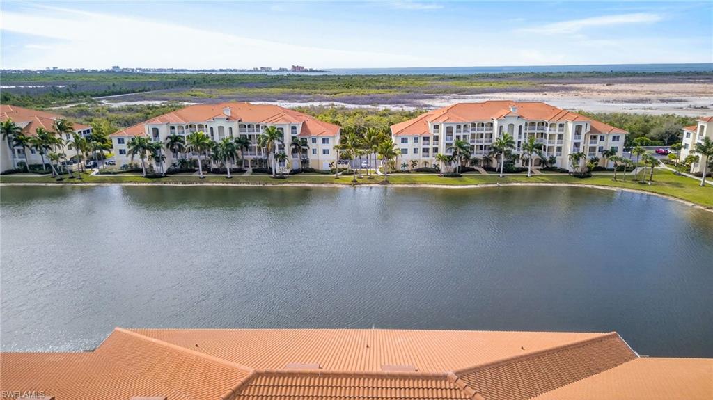 Aerial view of a nearby body of water and apartment complex / building