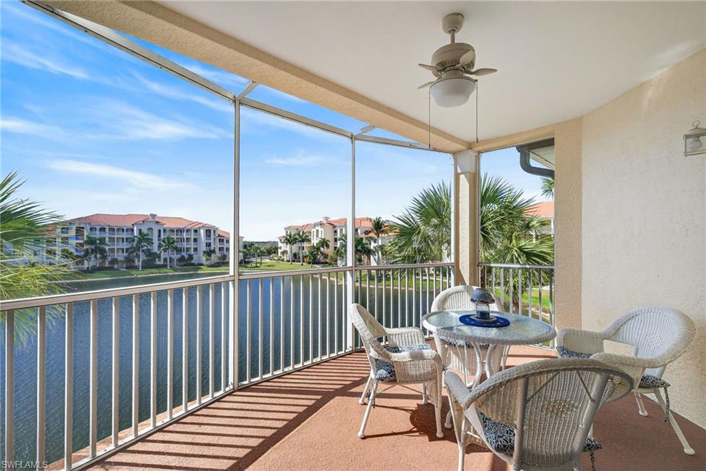 Sunroom / solarium featuring ceiling fan, a balcony, and a water view