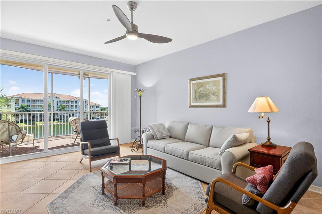 Living room with light tile patterned floors and ceiling fan