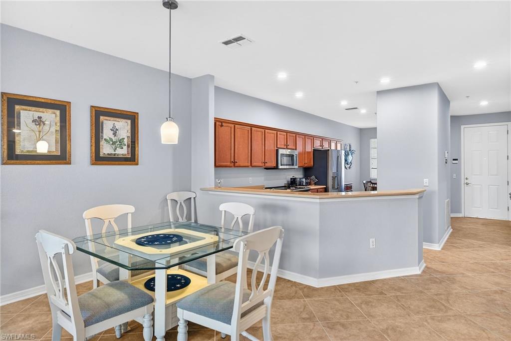 Dining room with recessed lighting and light tile patterned floors