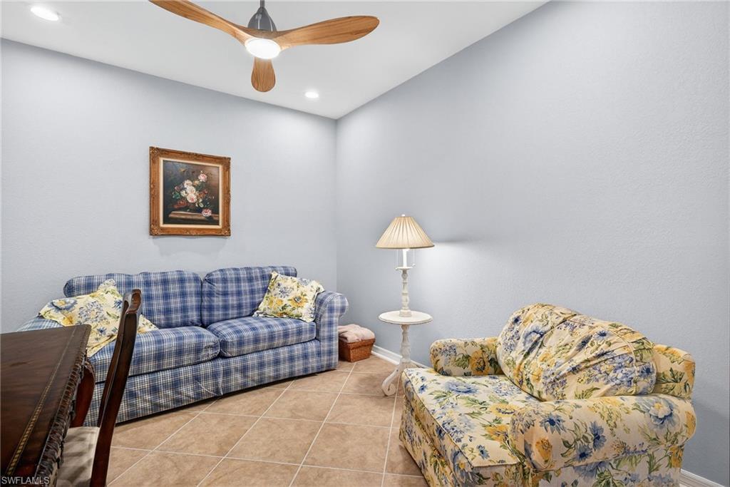 Living area with tile patterned flooring and a ceiling fan