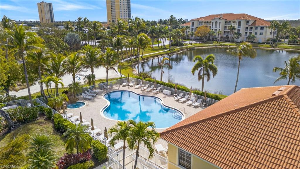 Community pool with a patio area and a water view