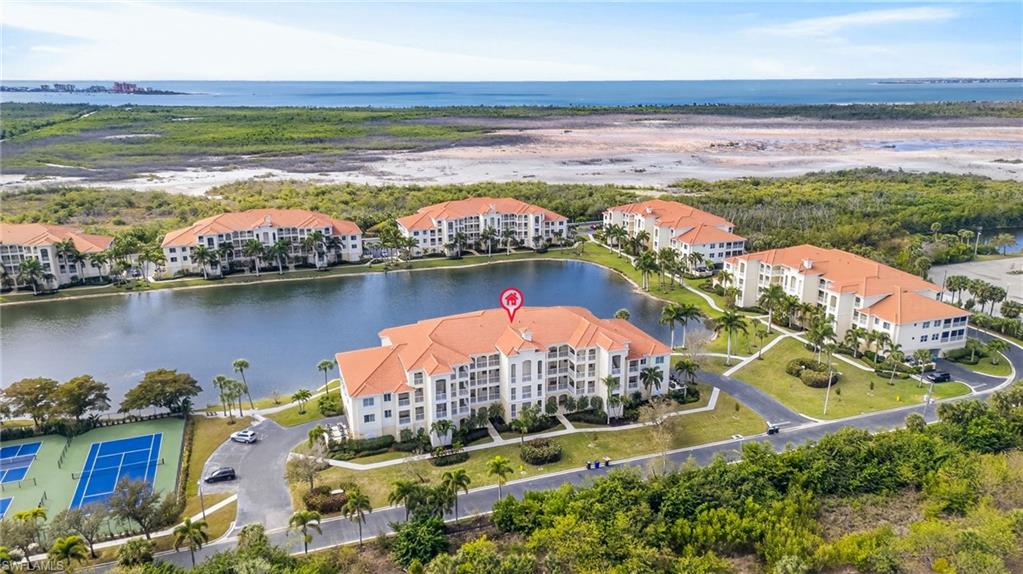 Drone / aerial view of apartment complex / building and a nearby body of water