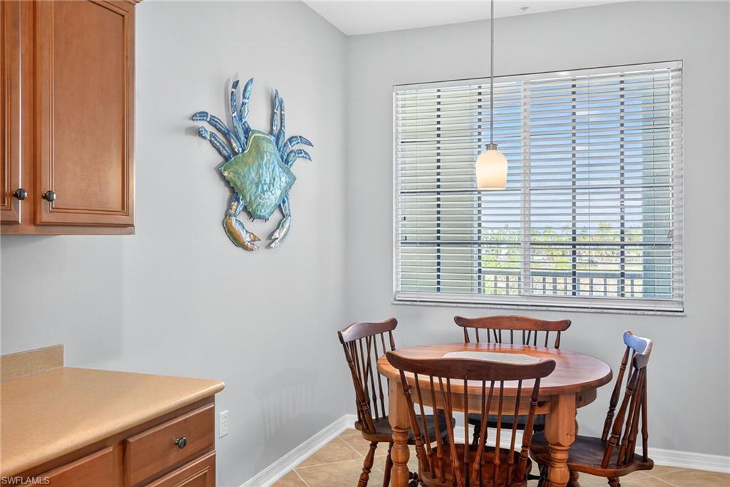 Dining room featuring light tile patterned floors and healthy amount of natural light
