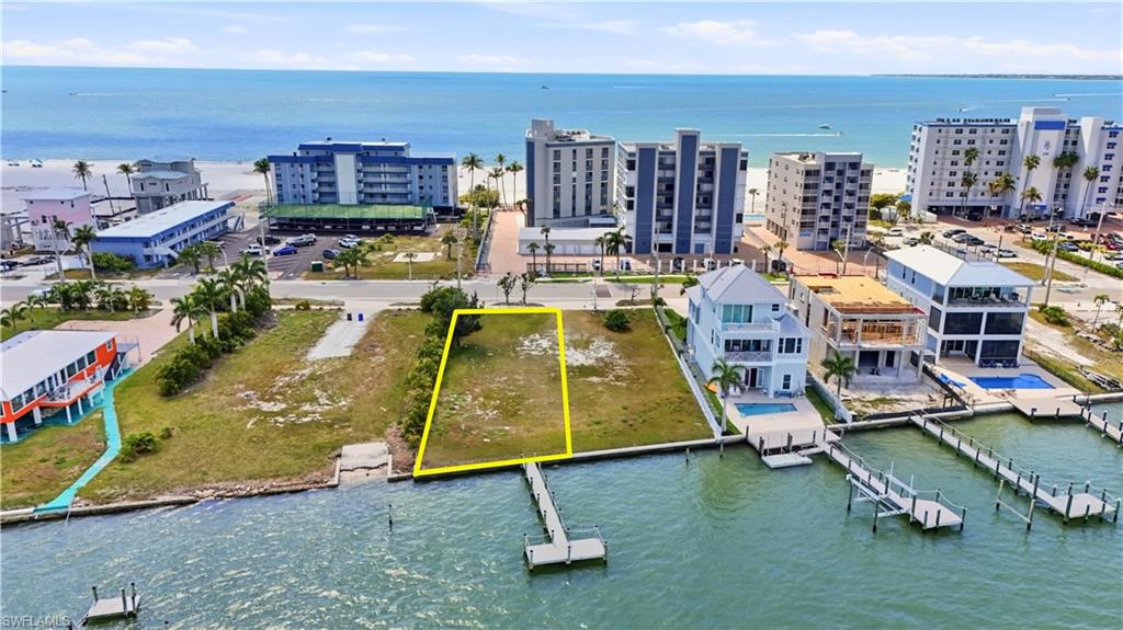Aerial overview of property's location with a nearby body of water and property parcel outlined - Virtually Edited Image
