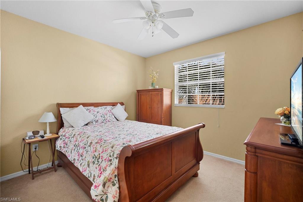 Bedroom featuring light carpet and a ceiling fan