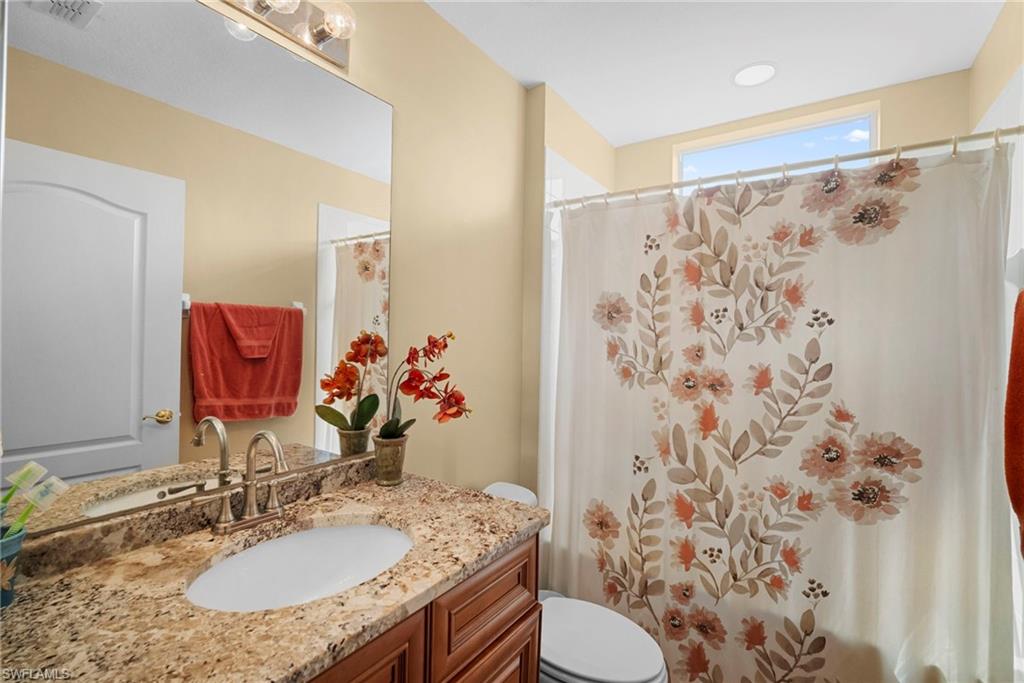 Full bathroom with vanity and toilet