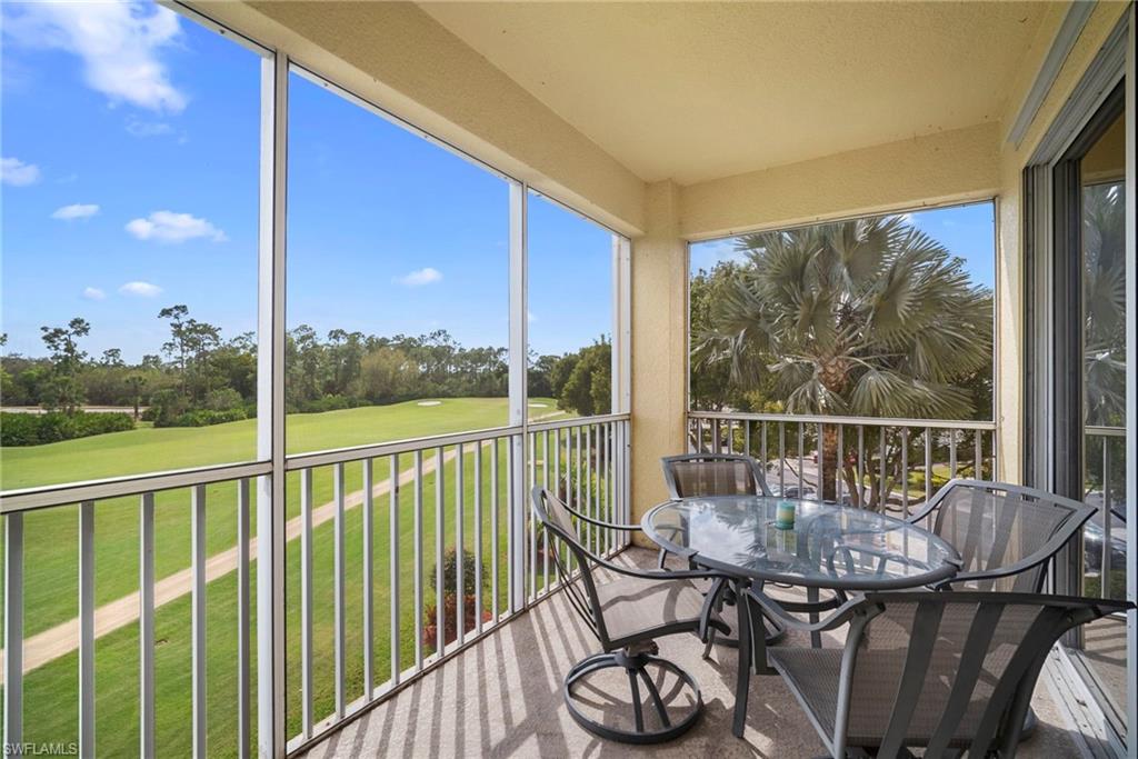 Sunroom featuring view of golf course