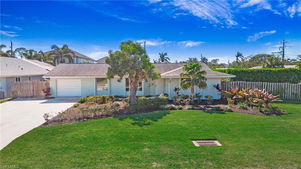 Single story home featuring concrete driveway, an attached garage, and stucco siding