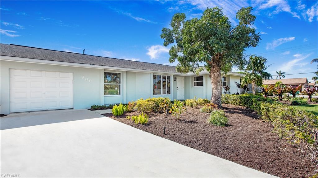 Single story home featuring stucco siding, driveway, and an attached garage