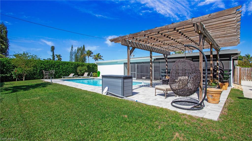 View of swimming pool featuring a pergola, patio surround, and a fenced backyard