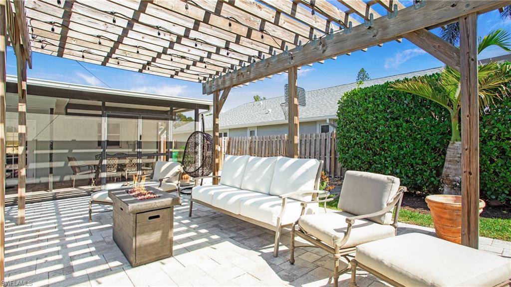View of patio with a pergola and an outdoor living space with a fire pit
