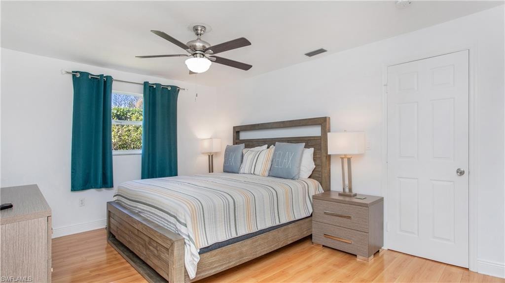 Bedroom with light wood finished floors and a ceiling fan