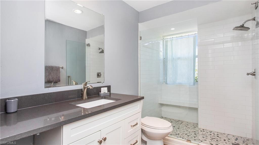 Bathroom featuring vanity, walk in shower, and recessed lighting