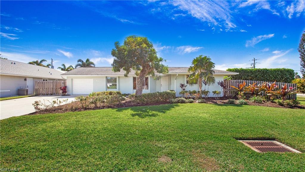 Ranch-style house with driveway, an attached garage, and stucco siding