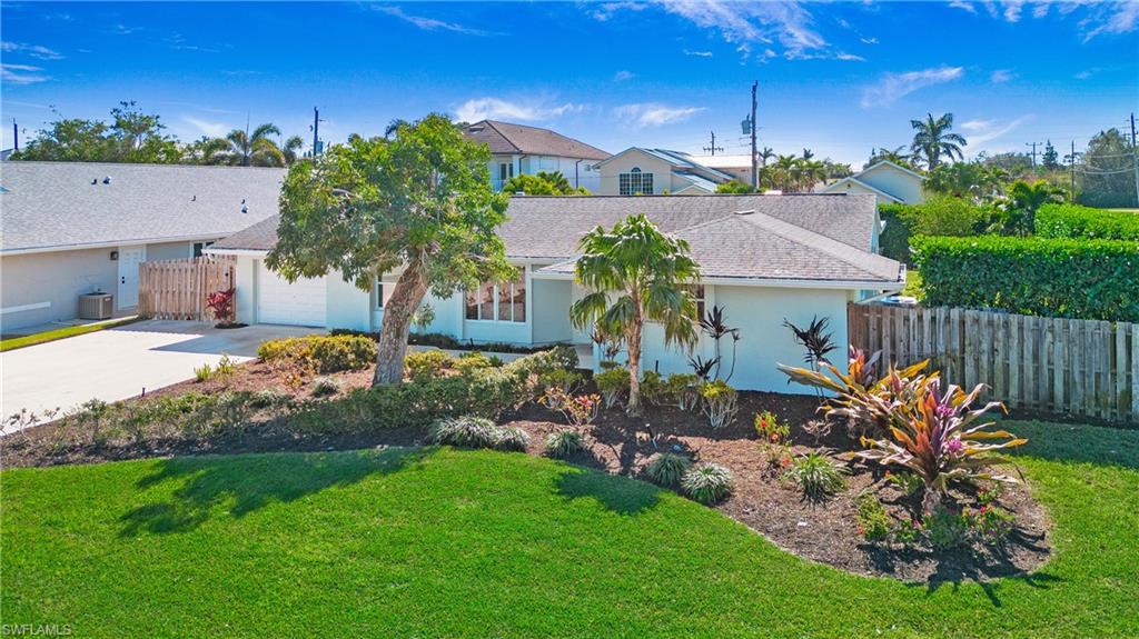 View of front of house featuring concrete driveway, stucco siding, and an attached garage