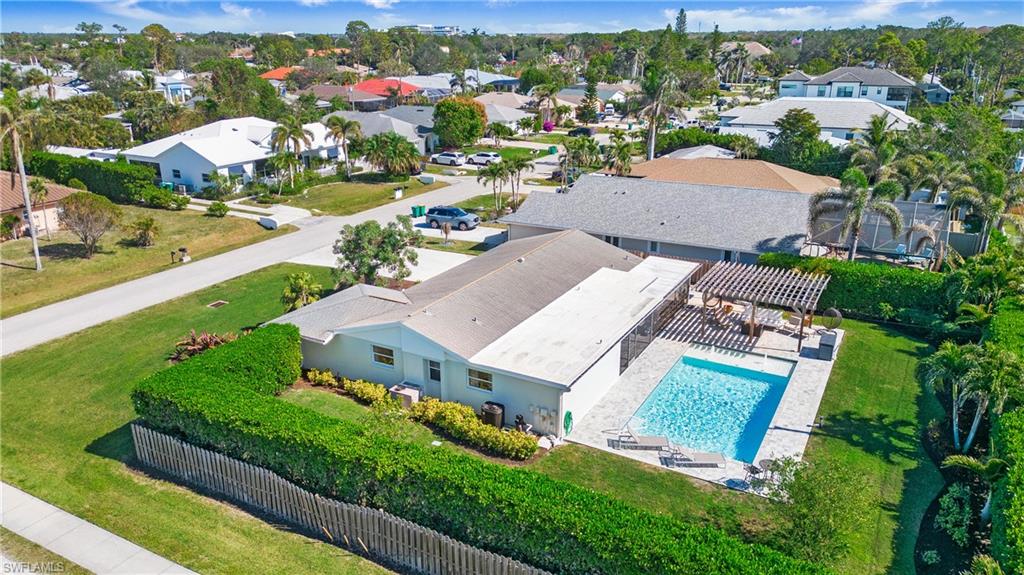 Aerial view of residential area featuring a pool area
