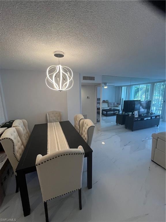 Dining area featuring a textured ceiling and hanging lights