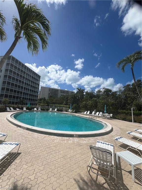 Community pool with a patio