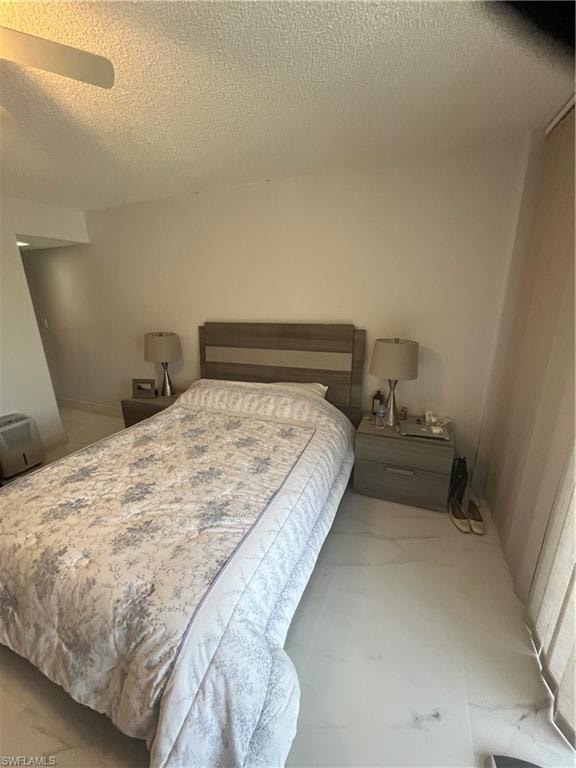 Bedroom featuring a textured ceiling and ceiling fan