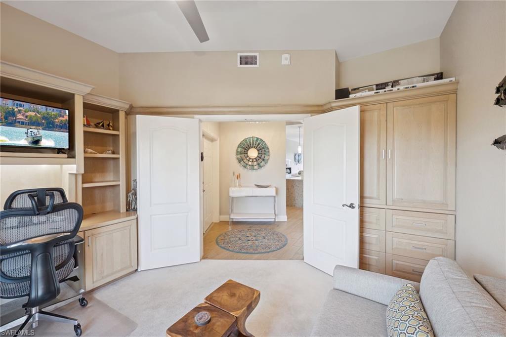 Bedroom #3 featuring light carpet, built in desk, and a ceiling fan