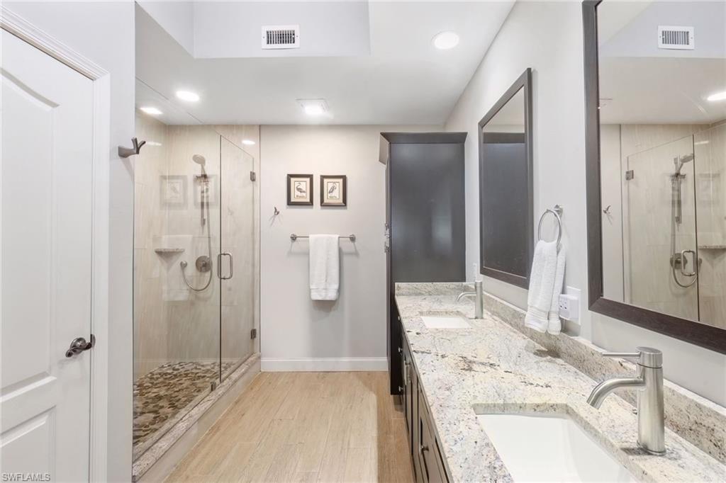 3/4 Bathroom featuring double vanity, walk-in shower
