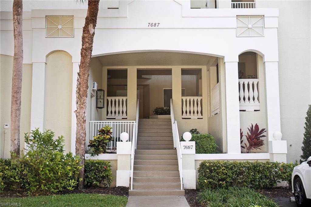Property entrance with stucco siding and covered porch