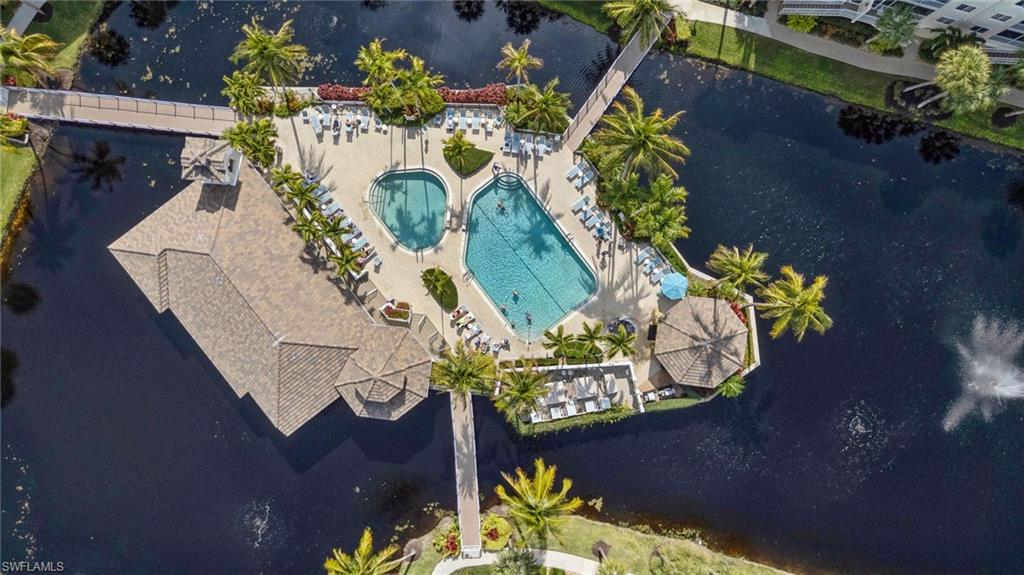 Bird's eye view of a pool area and a nearby body of water
