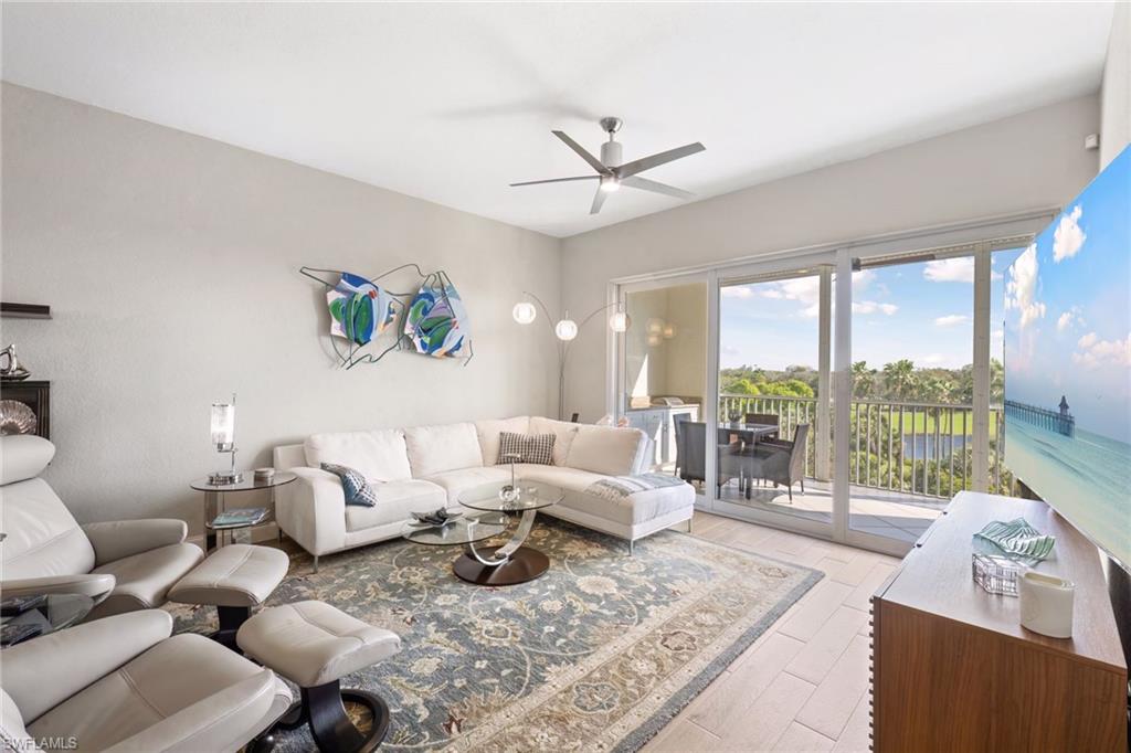 natural light-filled living room features golf course views