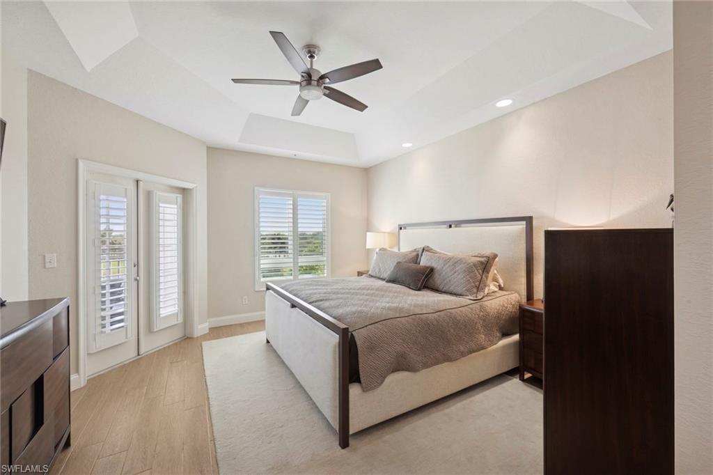 Bedroom #1, featuring access to outside balcony, a coffered ceiling