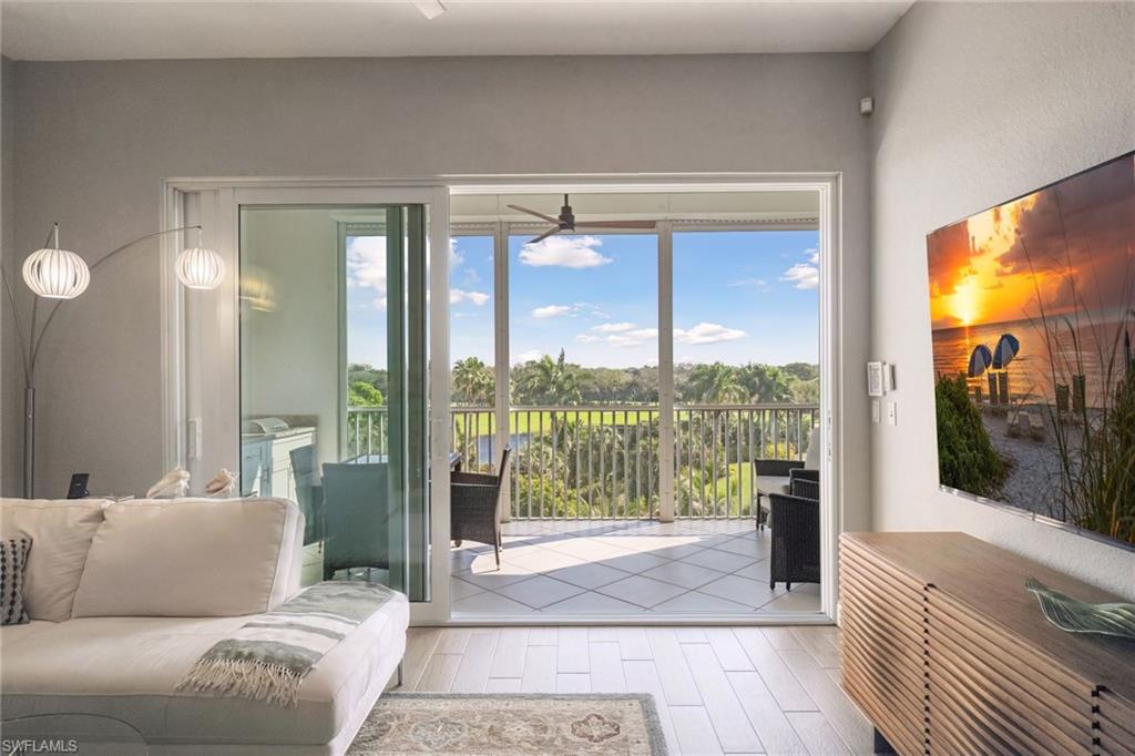 natural light-filled living room features golf course views