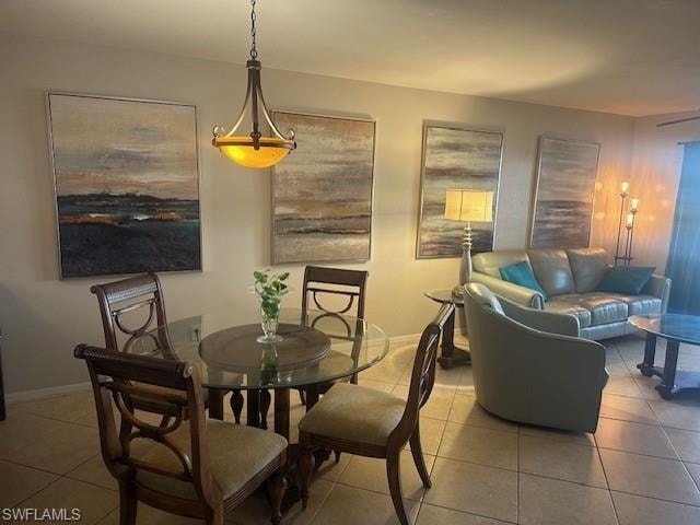 Dining room and living area featuring tile floors with views of lake