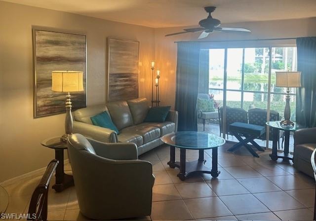 Tiled living area with leather seating, large screen TV, ceiling fan