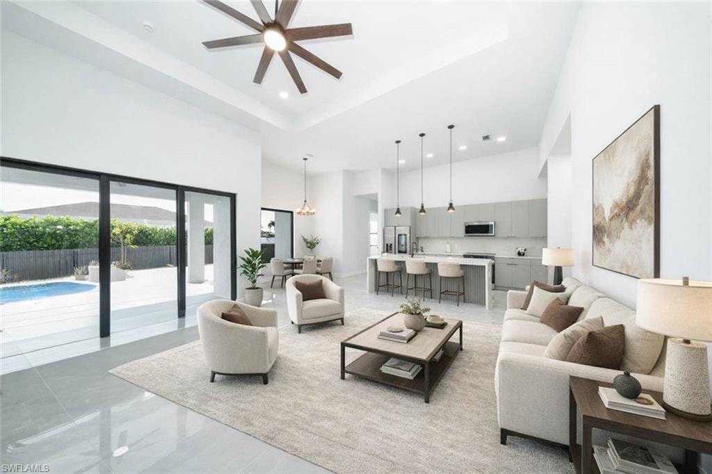 Kitchen with stainless steel appliances, modern cabinets, gray cabinets, an island with sink, and pendant lighting