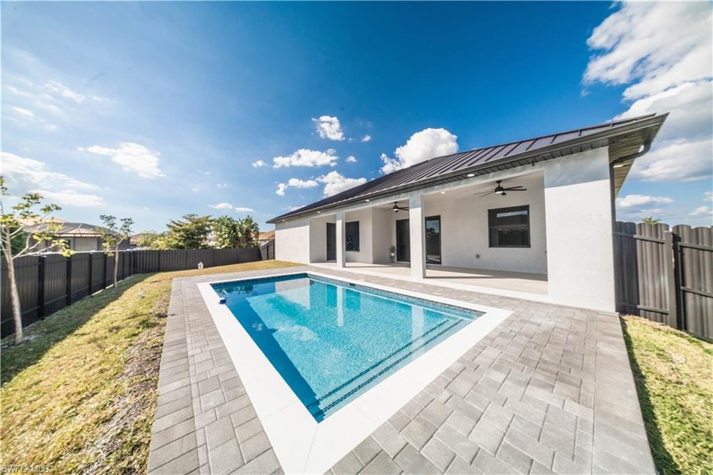 View of pool with a fenced backyard and patio surround