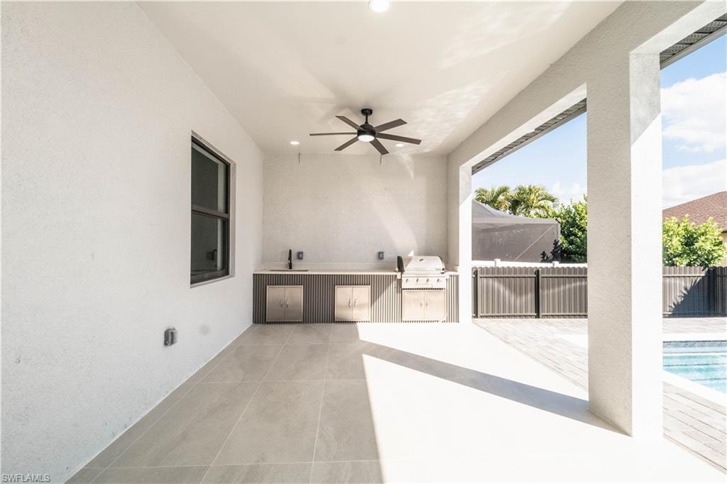 View of patio / terrace with an outdoor kitchen and ceiling fan