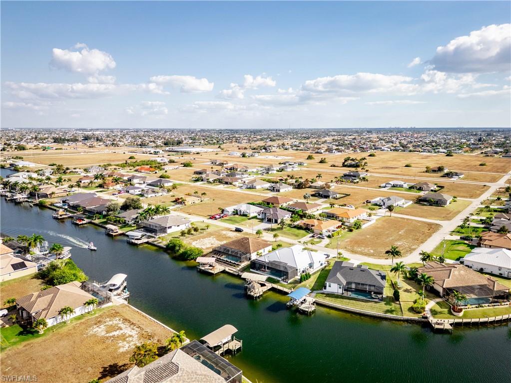 Aerial perspective of suburban area featuring a nearby body of water