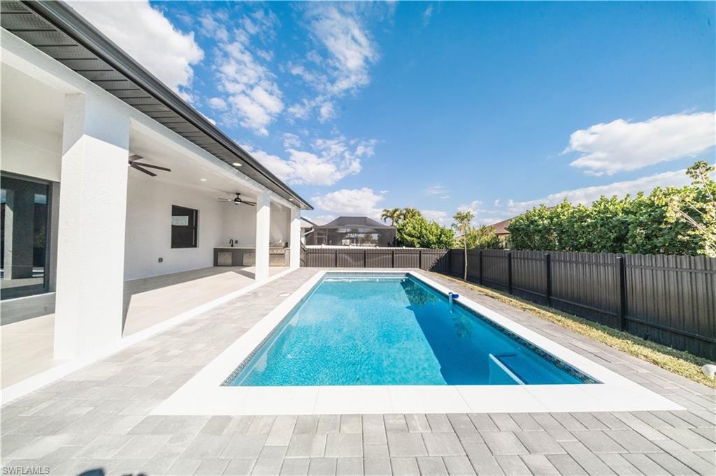 View of pool featuring patio surround and a fenced backyard
