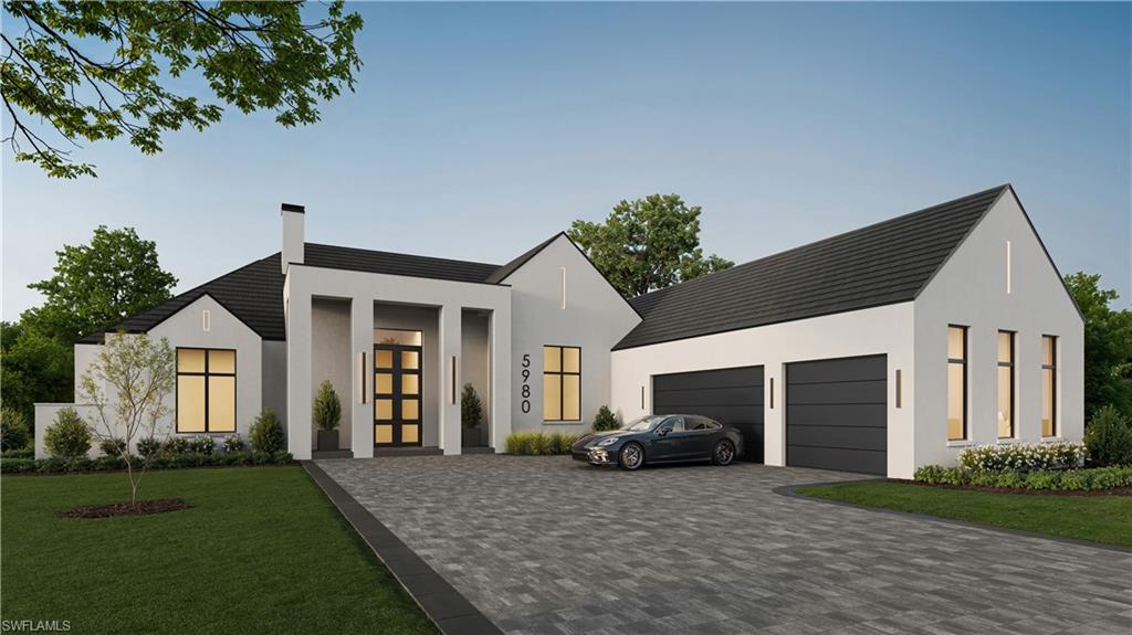 Contemporary home with a chimney, decorative driveway, a front lawn, stucco siding, and a garage