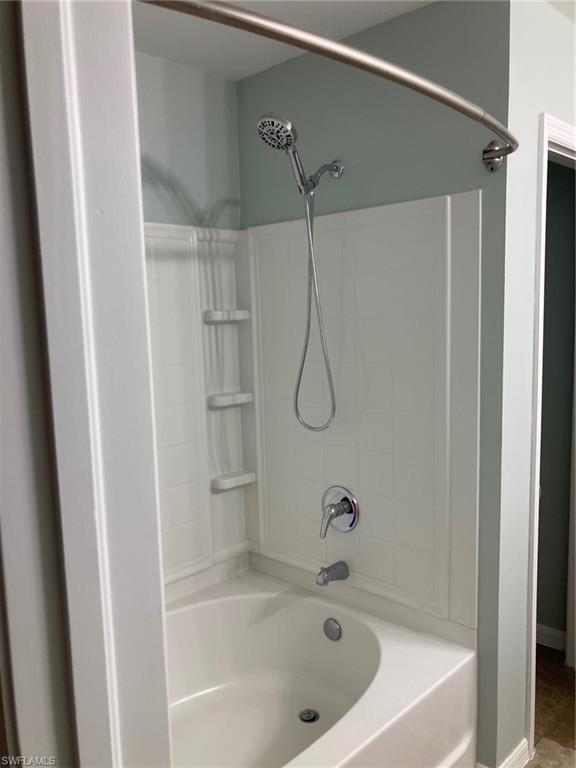 Primary Full bath featuring washtub / shower combination